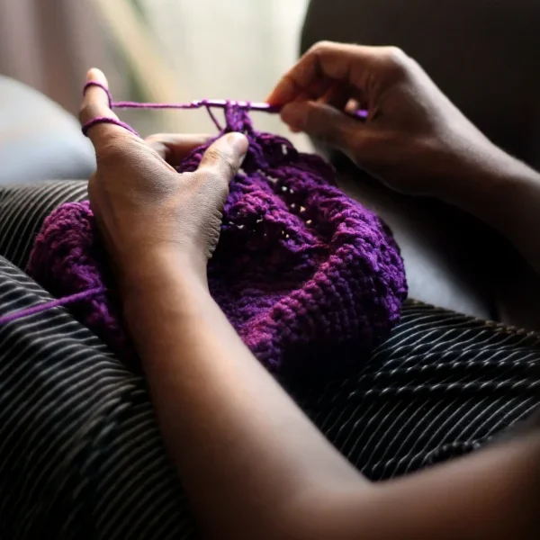Woman sewing purple textile stockpack unsplash scaled
